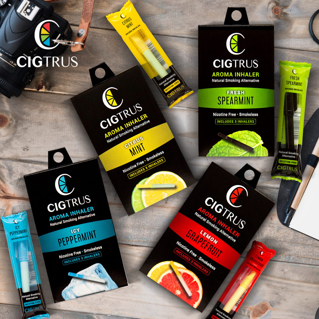Cigtrus nicotine-free aroma inhalers in citrus, mint, peppermint, spearmint flavors displayed on a wooden surface.