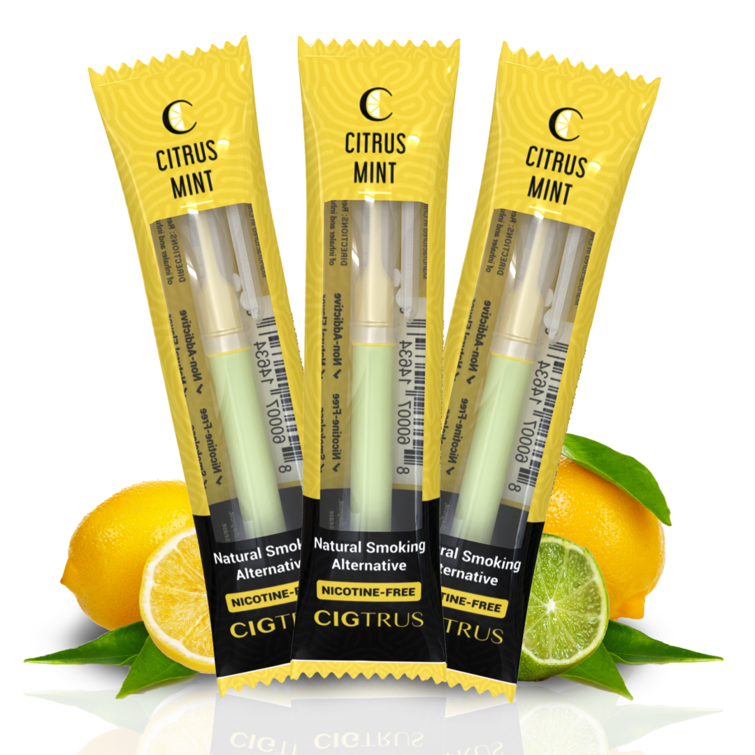 Three lemon-flavored nicotine-free vape pens in yellow packaging with citrus fruits in the background.
